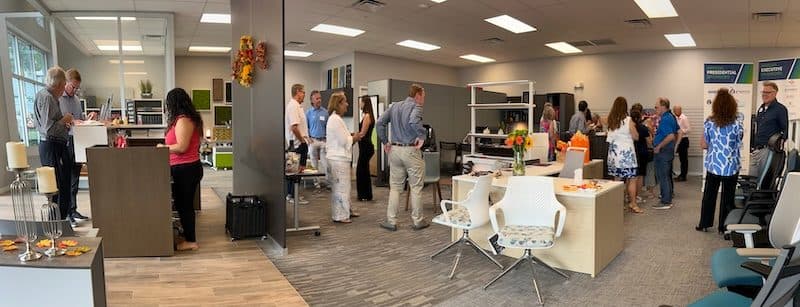 Networking event in the OFDC showroom, guests mingling among furniture vignettes, task chairs and banner stands