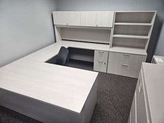 Private office with a U-shaped desk, overhead storage, and hutch in light laminate — Collier County Sheriff's Office, furnished by OFDC.