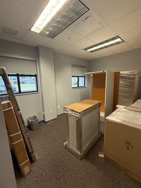 Government private office with a U-shape desk and overhead hutch in light-wood laminate