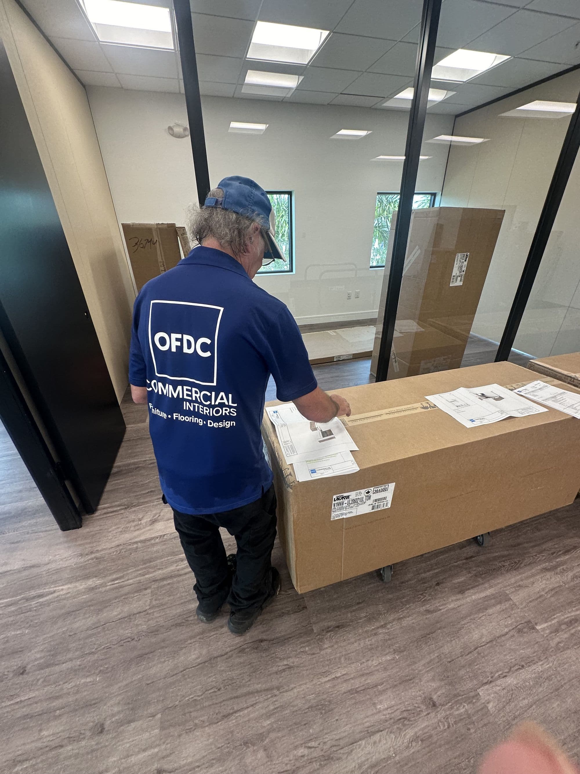 OFDC installer in branded polo and cap — in-house team, not subcontracted