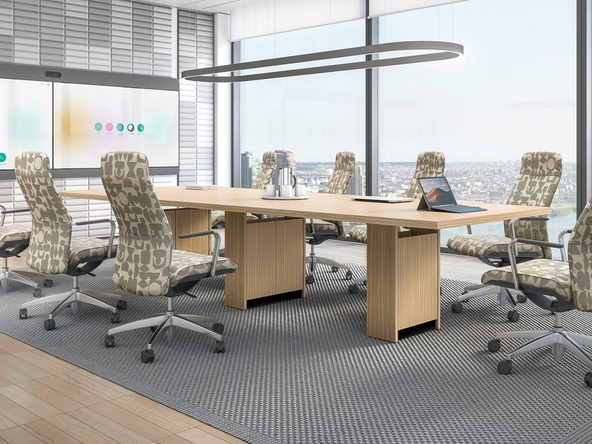 Light wood Global Zira conference table on pedestal bases with patterned high-back chairs