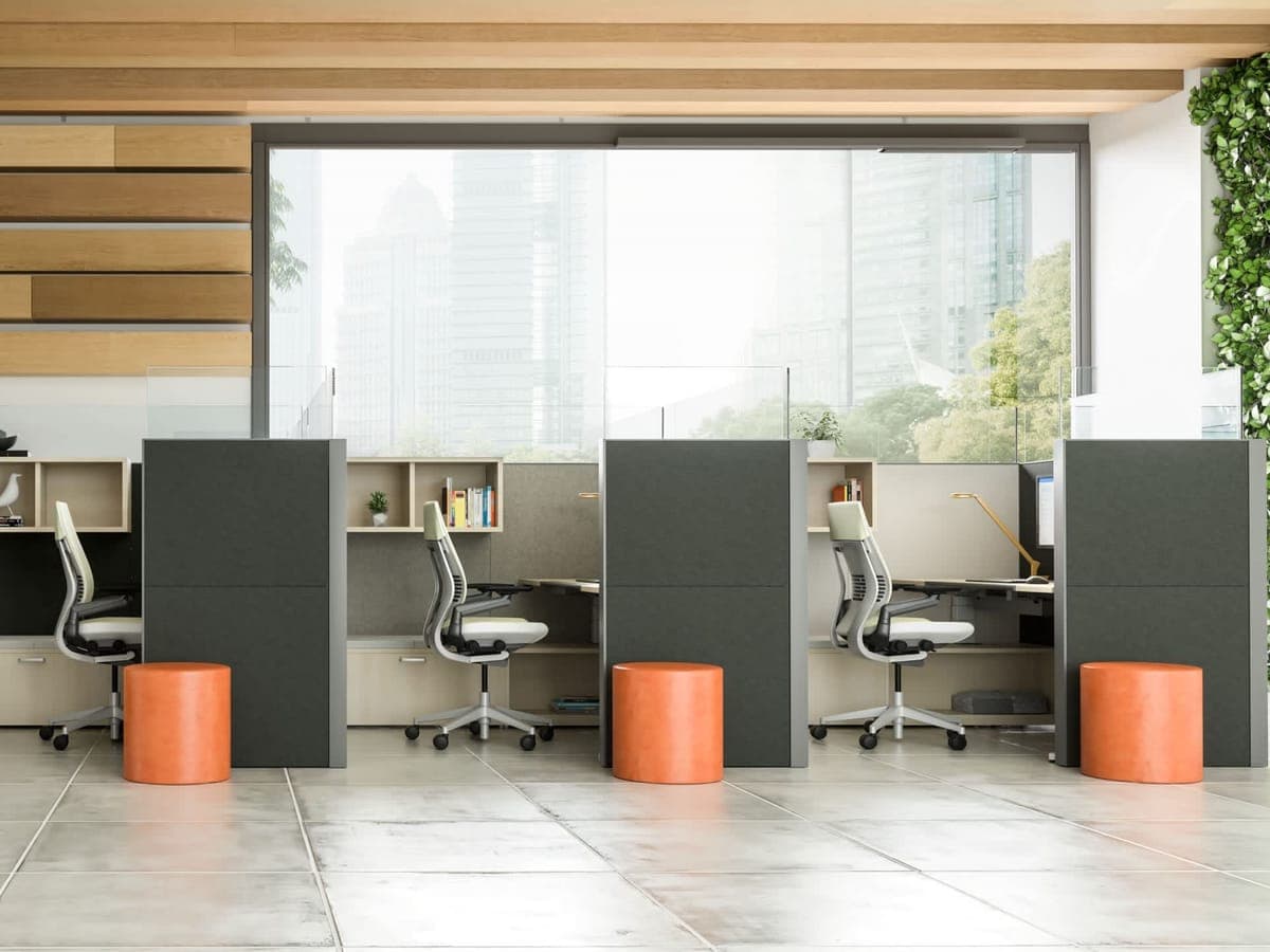 Row of Steelcase Answer workstations with dark end panels and orange stools