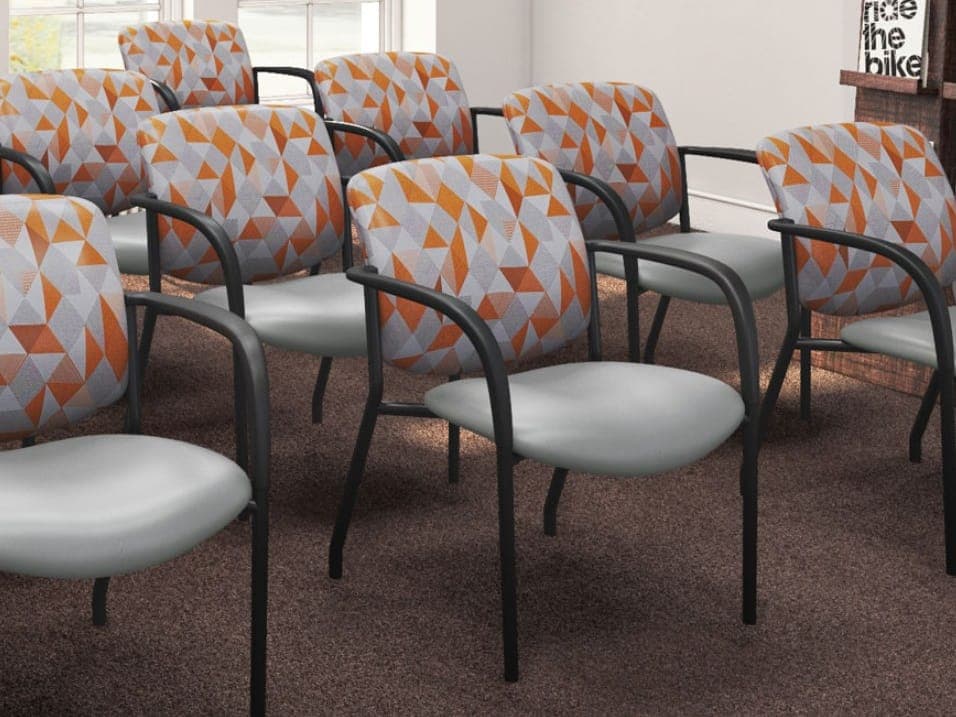 Rows of Buzz Seating Jem guest chairs with orange triangle-pattern backs