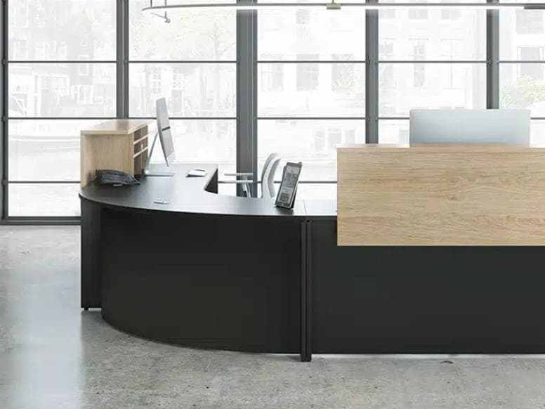 Curved black Lacasse reception desk with a light wood front