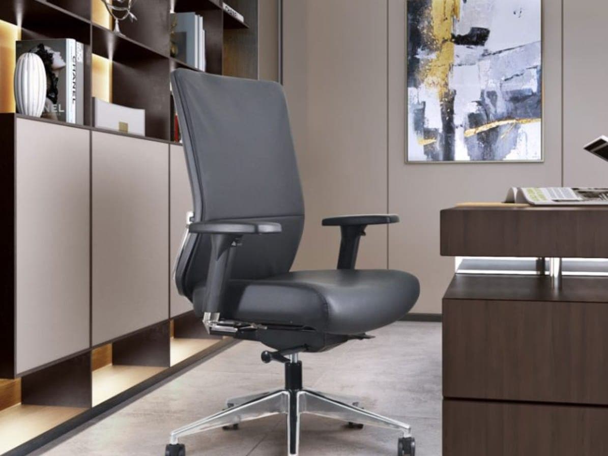 Black leather Buzz Seating Dapper chair at a dark wood desk